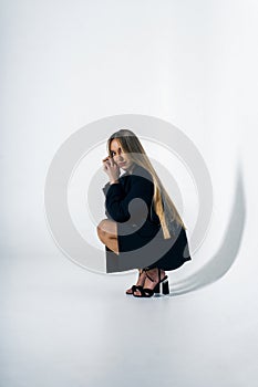 Gorgeous young adult woman posing in studio