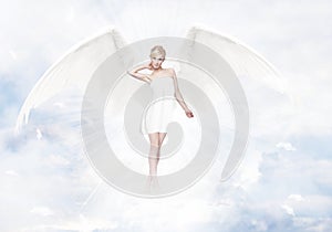 Gorgeous young blond woman as angel in heaven