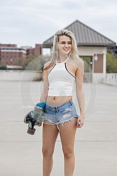 Gorgeous Young Coed Model Enjoying The Warm Weather With Her Skateboard