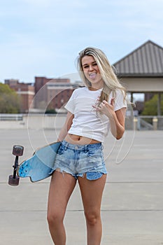 Gorgeous Young Coed Model Enjoying The Warm Weather With Her Skateboard