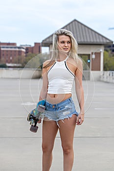 Gorgeous Young Coed Model Enjoying The Warm Weather With Her Skateboard