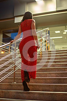 Gorgeous young girl walking up stairs.