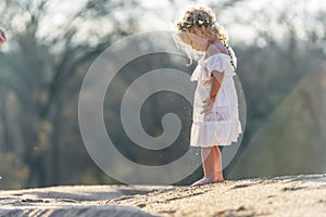 A Lovely Blonde Child Enjoys An Spring Day Outdoors photo