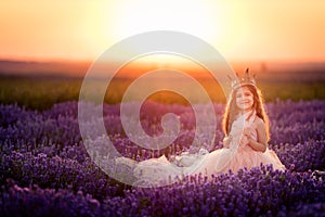Gorgeous young princess girl in the lavender field at sunset