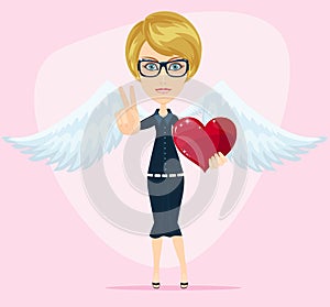 Gorgeous young woman as cupid angel with white wings and heart, with thumbs raised as a sign of victory.