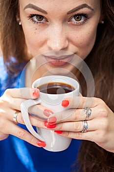 Gorgeous young woman drinking a cup of coffee