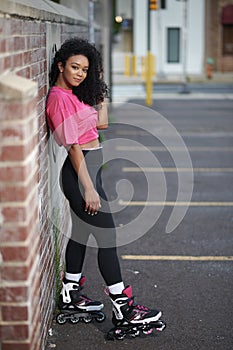 Gorgeous young woman in-line skates in city