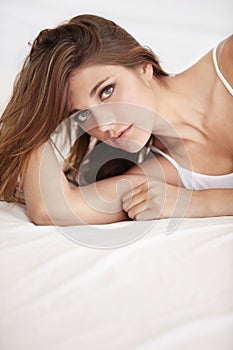 Simply stunning. A gorgeous young woman lying in bed above copyspace.