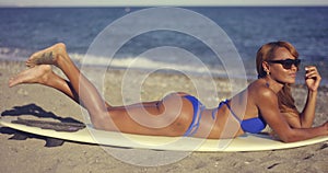 Gorgeous young woman sunbathing in a bikini