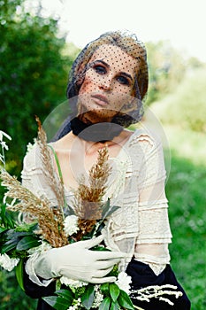 Woman holding bunch of wildflowers