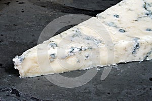Gorgonzola cheese on grey slate.