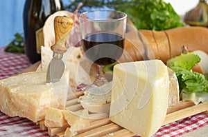 Gorgonzola, parmigiano, pecorino cheese, with wine and bread photo