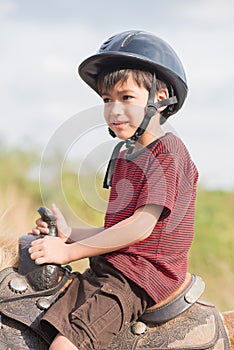 Gorgous Little boy riding horse