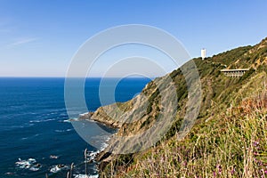Gorliz lighthouse on Biscay coast cliff photo