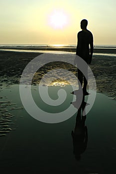 Gormley statue on the beach at Liverpool