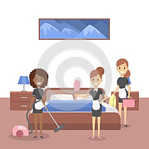 Gorup of maids cleaning hotel room. Female staff