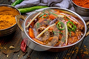 Gosht masala indian food in a copper on blue wooden table photo
