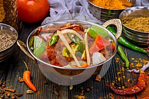 Gosht masala indian food in a copper on blue wooden table