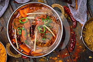 Gosht masala indian food in a copper on blue wooden table top view