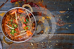Gosht masala indian food in a copper on blue wooden table top view with copy space photo