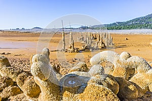Gossan Reservoir with orange stalagmites on shore, Andalusia, Sp