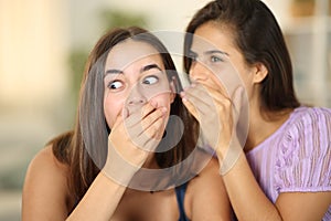 Gossip woman telling secret to the ear to a friend