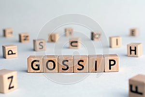 Gossip - word from wooden blocks with letters