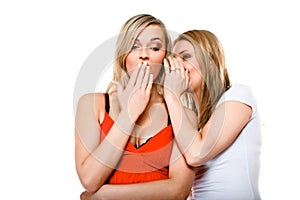 Gossiping friends, two women sharing a secret