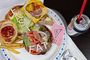 Got fat? letters on a juicy burger Unhealthy eating. Junk food concept
