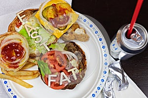 Got fat? letters on a juicy burger Unhealthy eating. Junk food concept