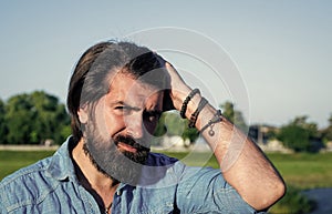 he got great style. confident and handsome guy spring portrait. brutal bearded man wear casual shirt and sunglasses