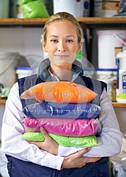 Got plastic. Portrait of a woman holding colorful bags of resin.