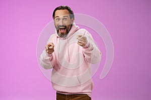 Gotcha. Portrait carefree funny amusing adult energized bearded man jumping pranking friend having fun laughing happily