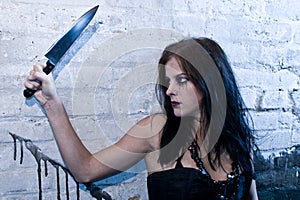 Goth girl holding a knife