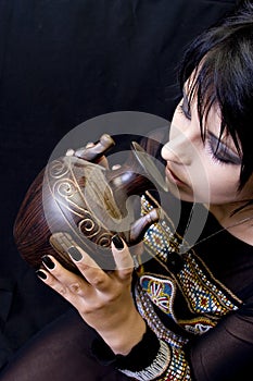 Goth Woman Drinks from a Vessel