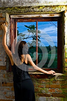 Goth woman at window