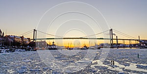 Gothenburg - Beautiful sunset at frozen Gota river with Hisingsleden Bridge in the harbor district during winter