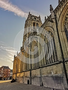 Gothic church Basilica of our Lady at the main square in Tongeren, Belgium, at sunset with a clear blue sky