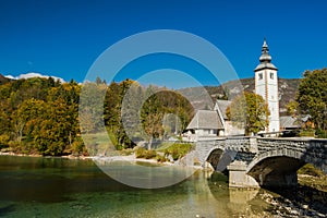 Gothic Church of St. John the Baptist and stone bridge in Ribcev Laz, lake Bohijn,Slovenia