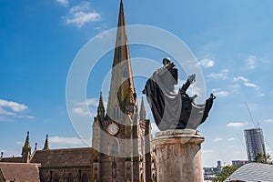 Gothic Church and Statue Against Modern Skyline in Birmingham, UK