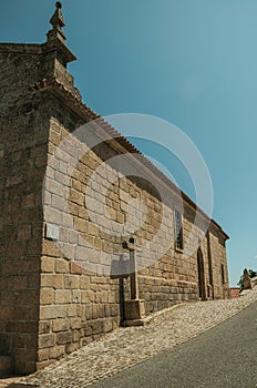 Gothic church with stone wall and cross at Monsanto