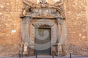 Gothic door with a bas relief and decorative ornament. Middle age church in Valencia