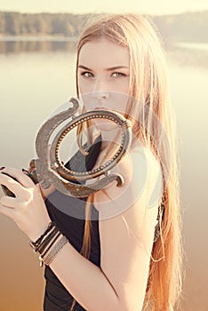 Gothic girl with long red hair and old mirror