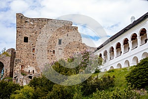 Gothic medieval castle Velhartice, sunny day, white mansion, facade with arches, masonry wall, old stronghold with tower,