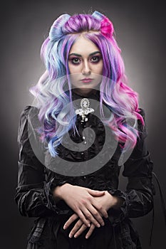 The gothic multi-colored hair girl on a gray background