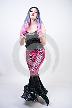 Gothic plus size adult mermaid on white studio background