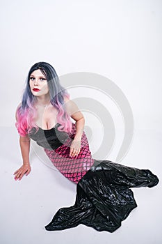 Gothic plus size adult mermaid on white studio background