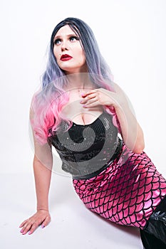 Gothic plus size adult mermaid on white studio background