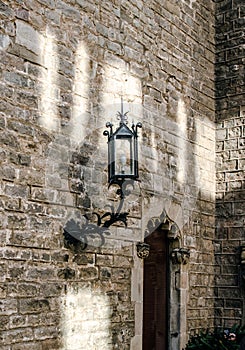 Gothic Quarter in Barcelona cityscape photo. Old brick wall and lantern. Street scene.