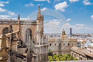 Gothic style with typical decoration in the Cathedral of Seville with windows and flying buttresses, in the background dome